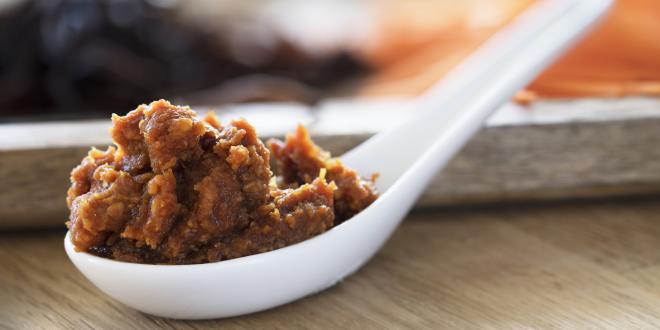 a soup spoon filled with red miso paste