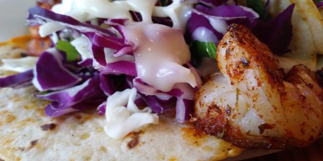 grilled shrimp on a tortilla with red cabbage and greek yogurt